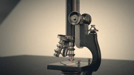 Medical-and-biology-concept.-An-old,-vintage-microscope-in-the-laboratory.-Professional-scientific-equipment-with-macro-lenses-used-to-study,-test-and-analyze-microbes,-bacteria-and-cells.