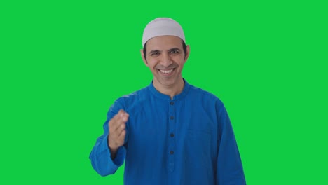 Happy-Muslim-man-doing-Adaab-and-greetings-Green-screen