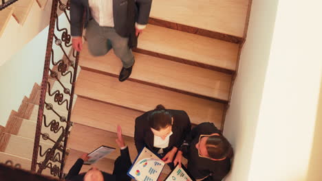 Top-view-of-businesswomen-discussing-on-staircase