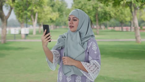 Muslim-woman-talking-on-video-call-in-park