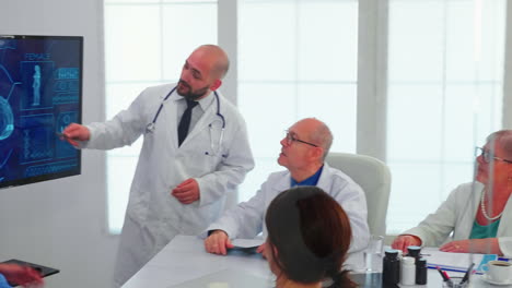 Doctor-talking-about-brain-activity-during-conference-with-medical-staff