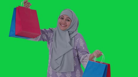 Happy-Muslim-woman-doing-shopping-Green-screen