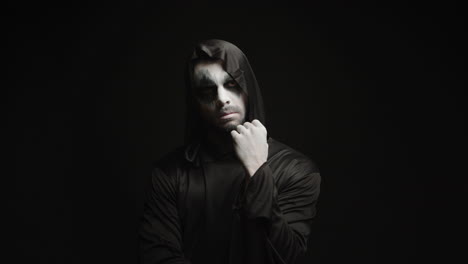 Thoughtful-scary-grim-reaper-over-black-background
