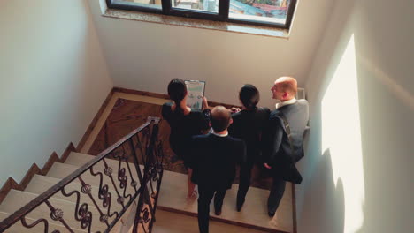 Business-team-going-up-together-in-conference-office-on-stairs