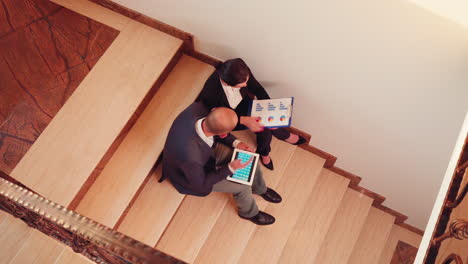 Top-view-of-project-team-working-on-stairs