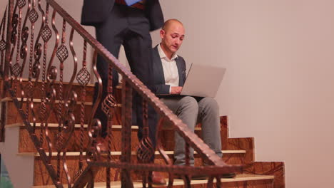 Tired-entrepreneur-smoking-and-working-on-stairs