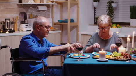 Man-in-wheelchair-dining-with-wife