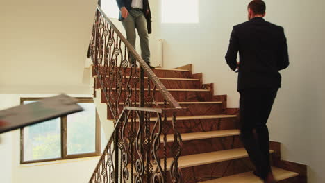 Business-people-climbing-stairs-in-finance-corporate-building