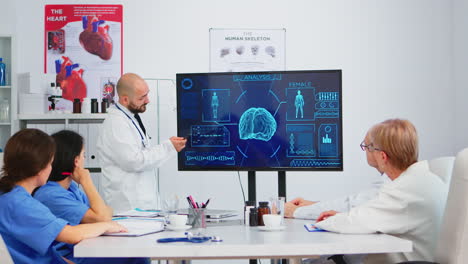 Medical-worker-presenting-report-on-digital-screen-about-internal-human-brain