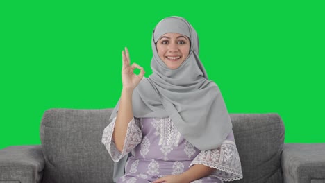Happy-Muslim-woman-showing-okay-sign-Green-screen