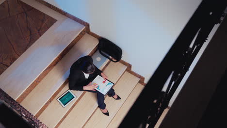 Top-view-of-overworker-woman-sitting-alone-on-stairs
