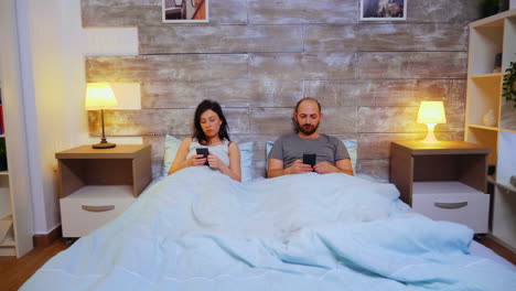 Zoom-in-shot-of-couple-laying-in-comfortable-bed