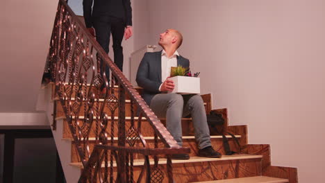 Fired-businessman-sitting-on-stairs
