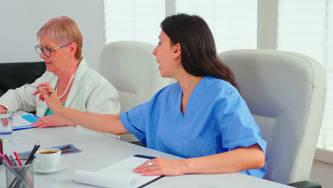 Close-up-of-medical-nurse-taking-notes-on-clipboard-during