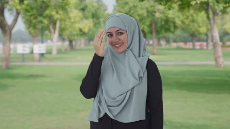 Happy-Muslim-woman-doing-Adaab-in-park