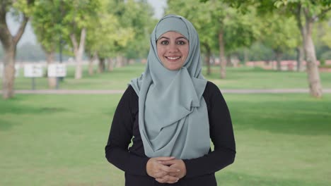 Happy-Muslim-woman-smiling-on-camera-in-park
