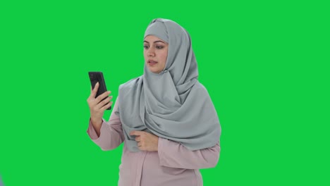 Muslim-businesswoman-talking-on-video-call-Green-screen
