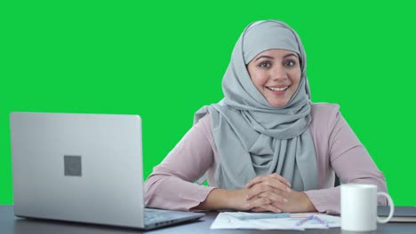 Happy-Muslim-businesswoman-talking-to-camera-Green-screen