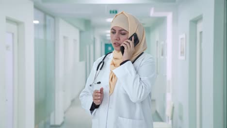 Muslim-doctor-talking-on-phone