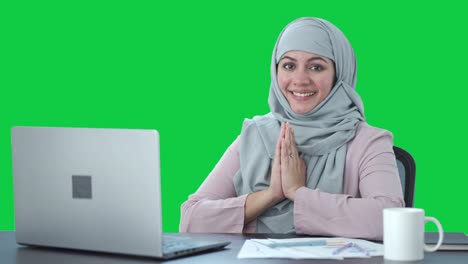 Happy-Muslim-businesswoman-doing-Namaste-Green-screen