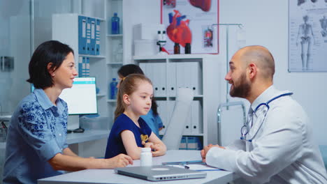 Child-and-doctor-talking-in-clinic