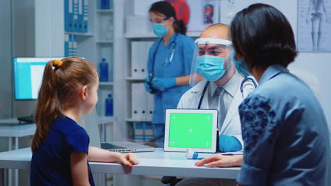 Doctor-holding-green-screen-tablet