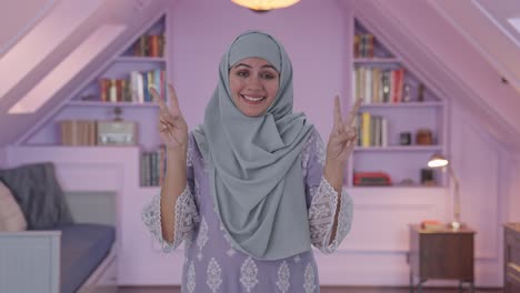Mujer-Musulmana-Feliz-Mostrando-El-Signo-De-La-Victoria