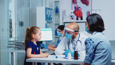 Little-girl-speaking-with-doctor-during-consultation