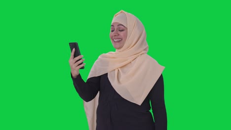 Happy-Muslim-woman-talking-on-video-call-Green-screen