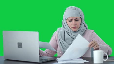 Frustrated-Muslim-businesswoman-working-in-office-Green-screen