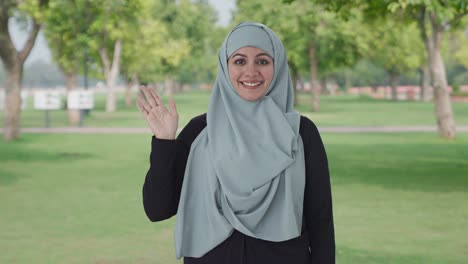 Happy-Muslim-woman-saying-Hi-in-park
