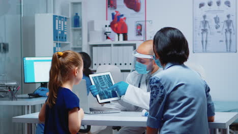 Physician-explaining-x-ray-using-tablet