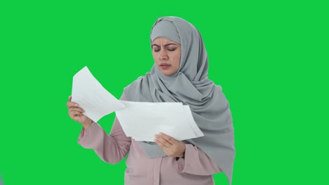Empresaria-Musulmana-Estresada-Leyendo-Informes-Pantalla-Verde