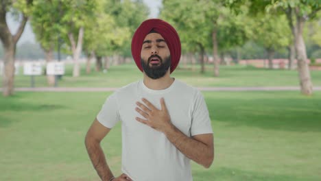 Sick-Sikh-Indian-man-suffering-from-cold-and-cough-in-park