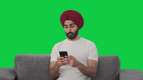 Sikh-Indian-man-chatting-with-someone-Green-screen