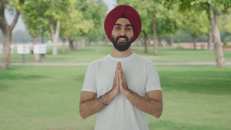 Happy-Sikh-Indian-man-greeting-and-doing-Namaste-in-park