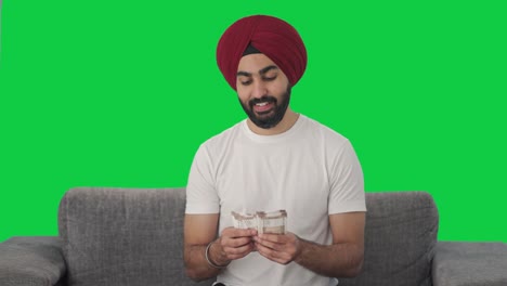 Fröhlicher-Sikh-Indianer,-Der-Geld-Zählt,-Grüner-Bildschirm