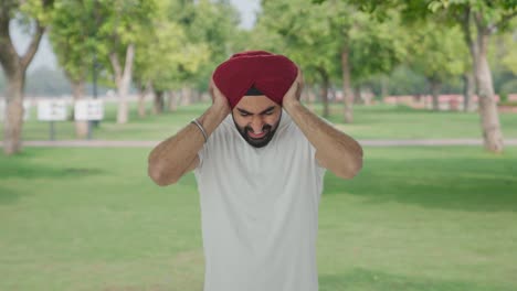 Angry-Sikh-Indian-man-shouting-with-closed-ears-in-park