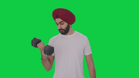 Sikh-Indian-man-lifting-heavy-dumbbells-Green-screen