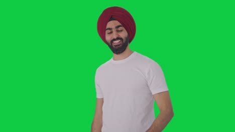 Fröhlicher-Sikh-Indianer,-Der-Jemanden-Auf-Grünem-Bildschirm-Anruft