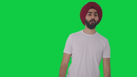Sikh-Indian-man-looking-and-searching-someone-Green-screen