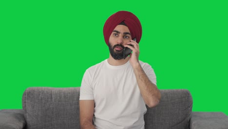 Sikh-Indian-man-talking-on-phone-Green-screen