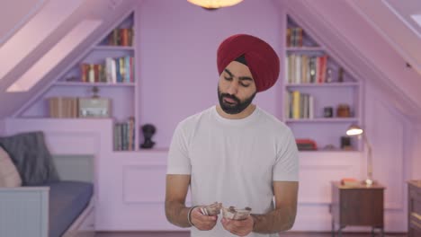 Sad-Sikh-Indian-man-counting-money
