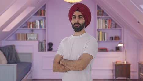 Portrait-of-Confident-Sikh-Indian-man-standing-crossed-hands