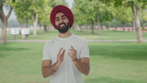 Happy-Sikh-Indian-man-clapping-and-appreciating-in-park