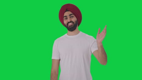 Fröhlicher-Sikh-Indianer-Sagt-Hallo,-Grüner-Bildschirm