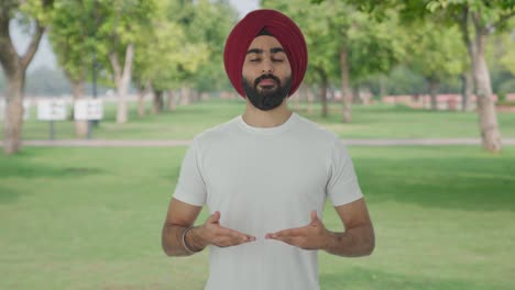 Sikh-Indian-man-doing-Yoga-in-park