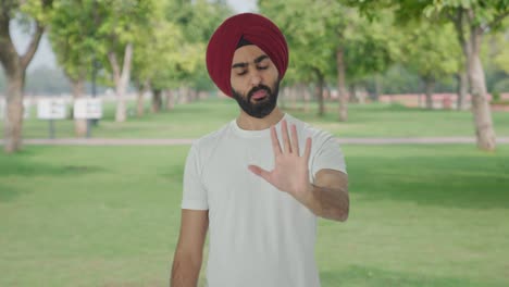 Angry-Sikh-Indian-man-stopping-someone-in-park
