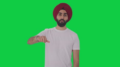 Disappointed-Sikh-Indian-man-showing-thumbs-down-Green-screen
