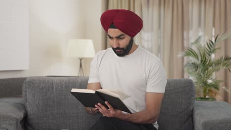 Sikh-Indian-man-reading-book-and-drinking-tea